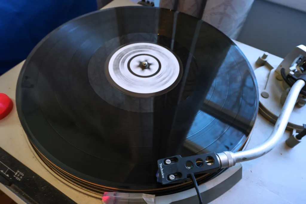 An LP record plays on a player inside Jacob's home.