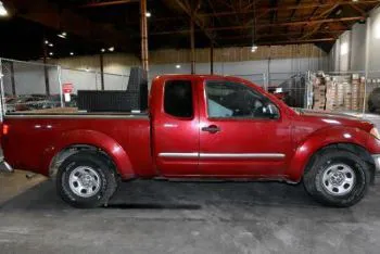 Red 2010 Nissan Frontier pickup truck.
