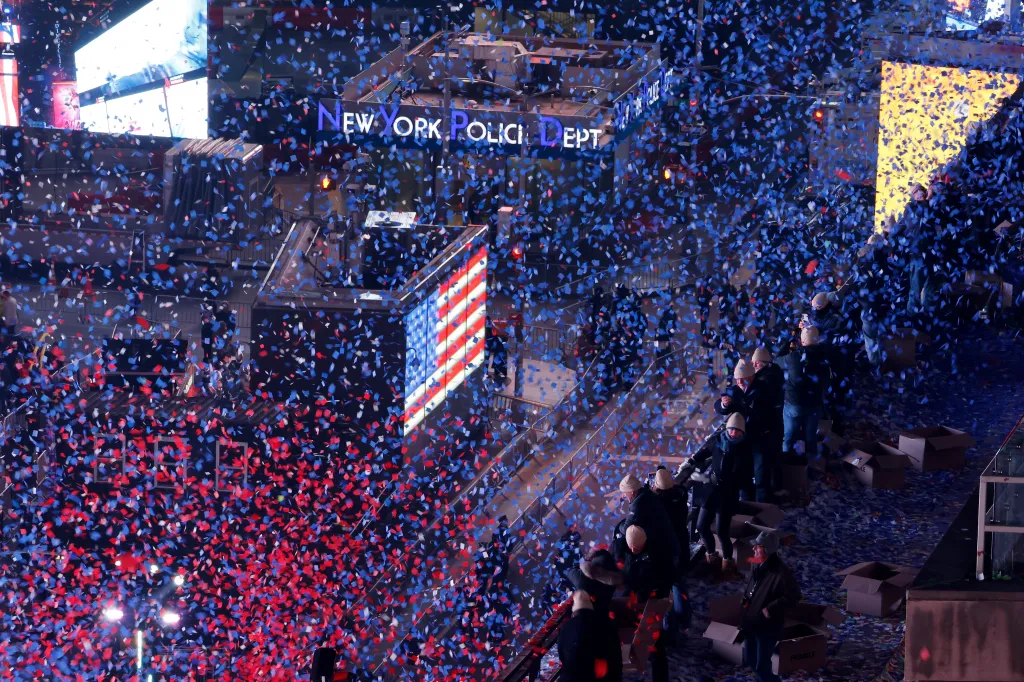 Red, white, and blue confetti falling over Times Square during the America250 New Year's Eve celebration.