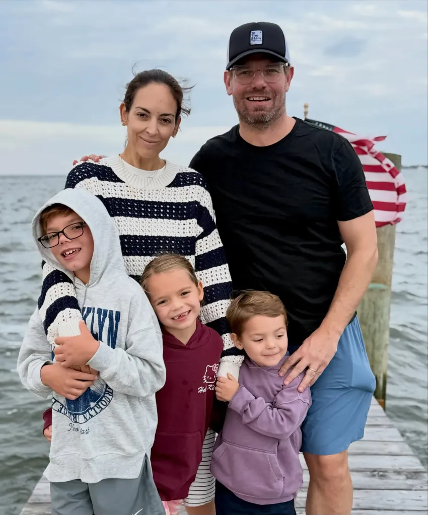 Rep. Eric Swalwell, his wife, Brittany Watts, and their three children pose for a family photo on a dock.