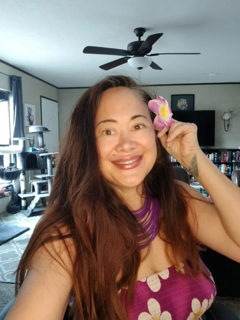 Asia Carrera with a pink flower behind her ear.