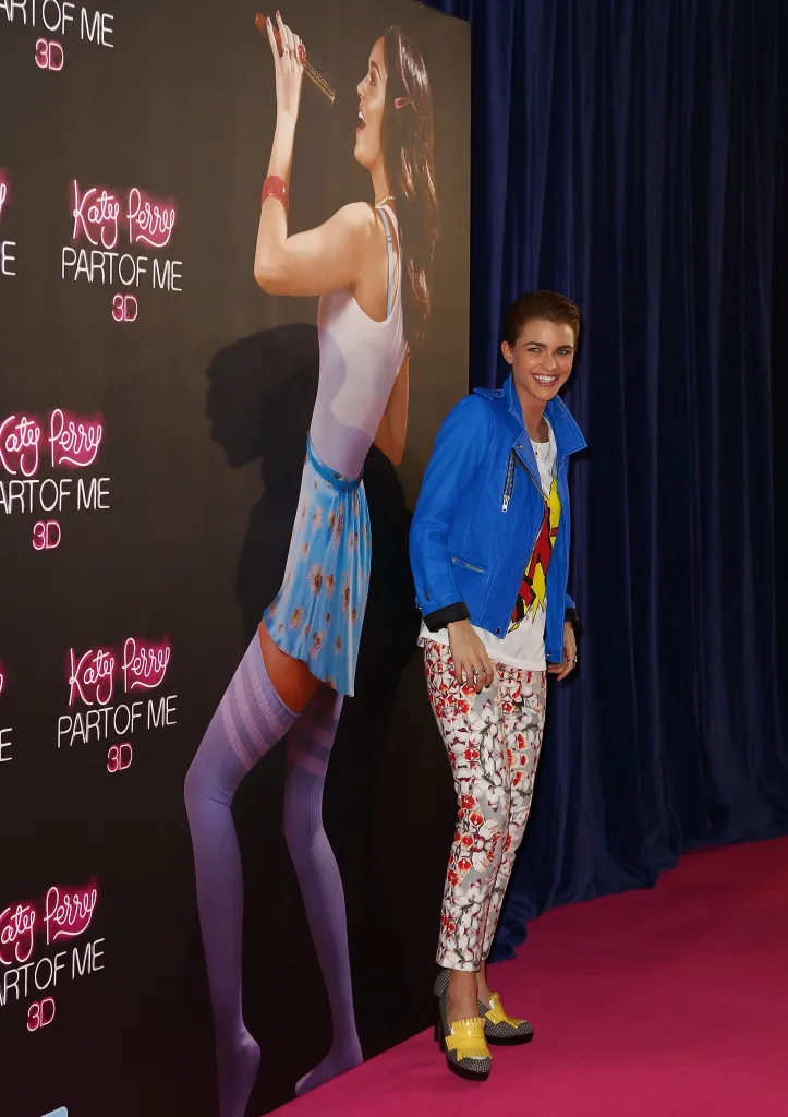 Ruby Rose smiles next to a Katy Perry standee at the 