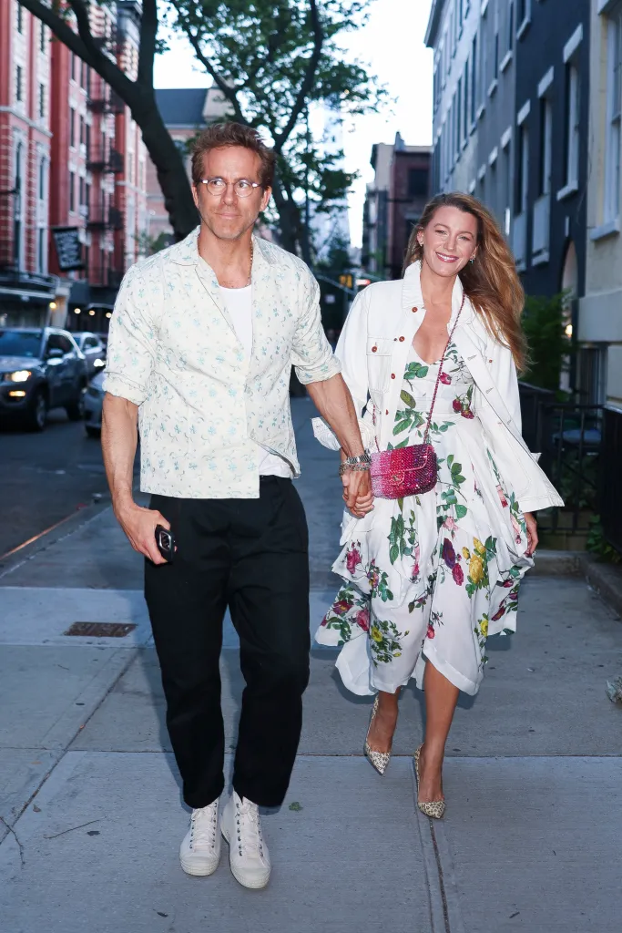 Ryan Reynolds and Blake Lively holding hands and smiling while walking in SoHo.