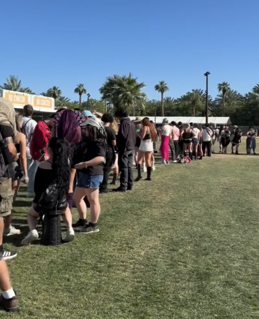 Festivalgoers in line for drinks under the sun.