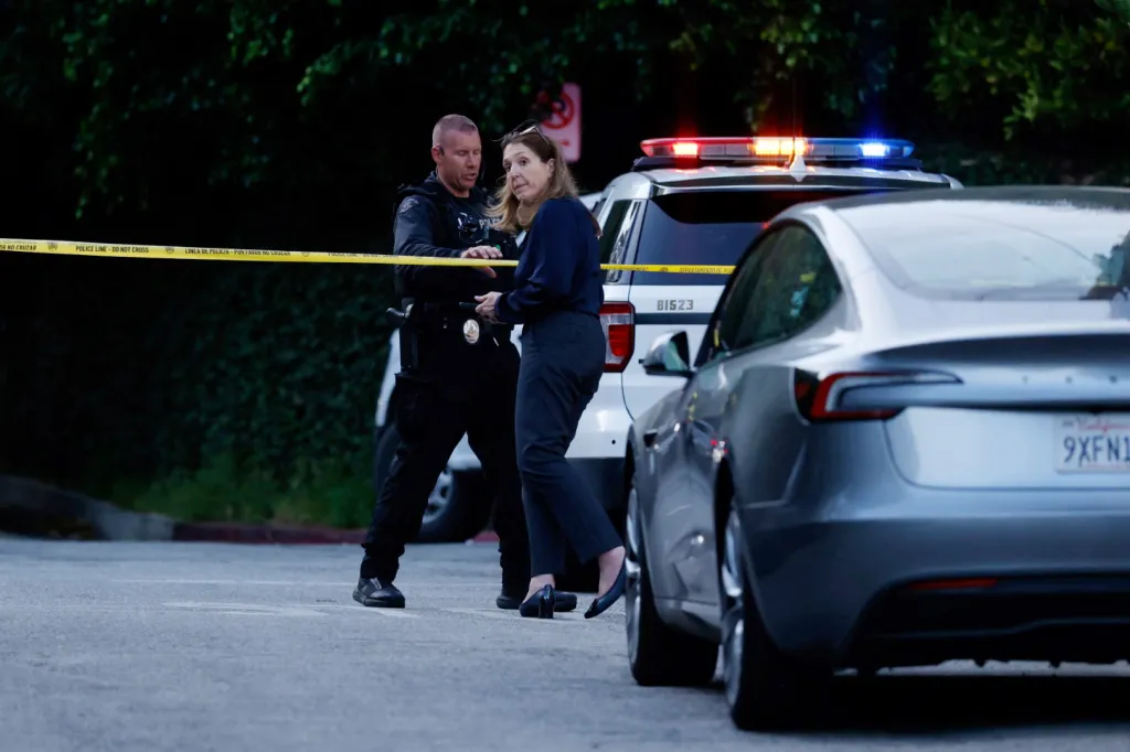 A police officer and a woman standing behind 