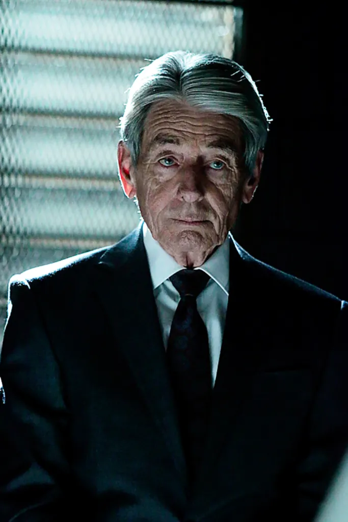 Portrait of John Nolan in a dark suit and patterned tie.