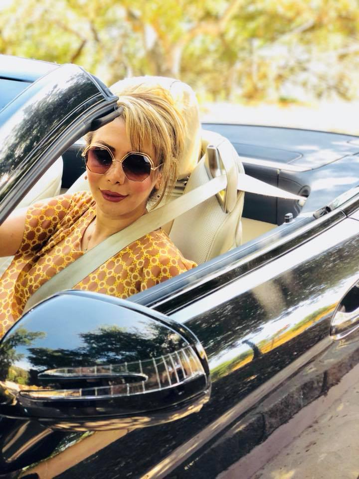 Shamim Mafi seated in a convertible car.
