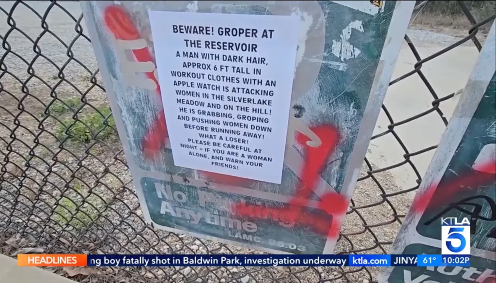 A flyer on a chain-link fence warns of a groper at Silverlake Reservoir, describing a man with dark hair, approximately 6 ft tall, in workout clothes with an Apple Watch, who is attacking women by grabbing, groping, and pushing them down.