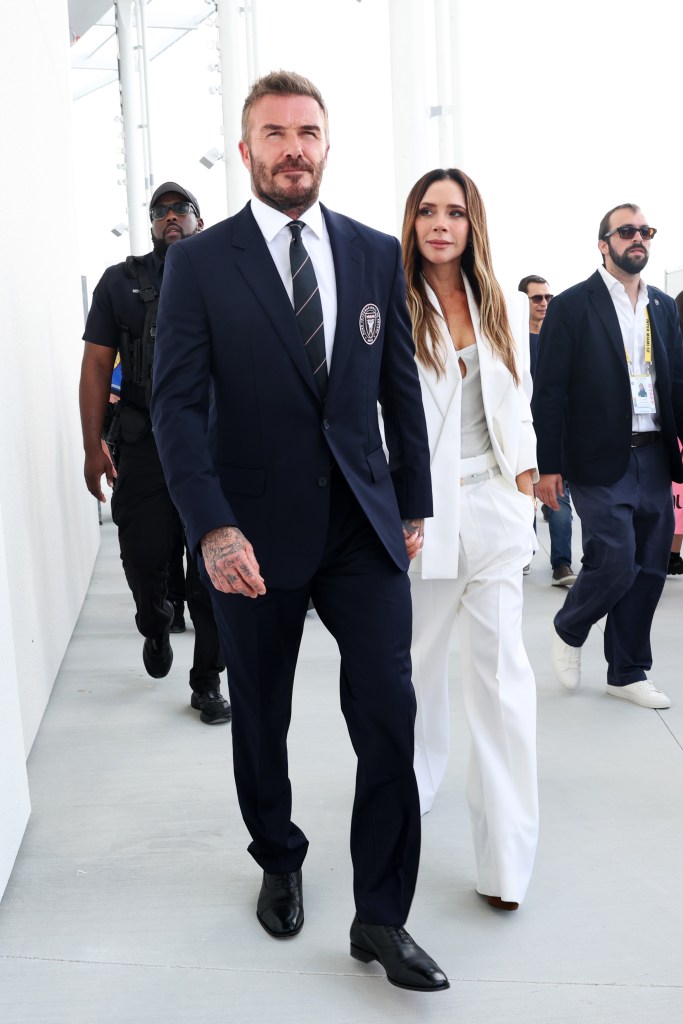 David Beckham, In a navy blue suit, and Victoria Beckham, in a white pant suit, attend the ribbon-cutting ceremony for Inter Miami CF stadium.