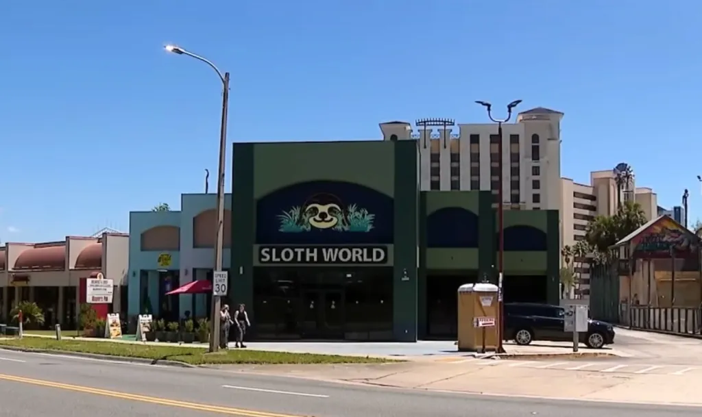 The exterior of the Sloth World Orlando building with its logo.