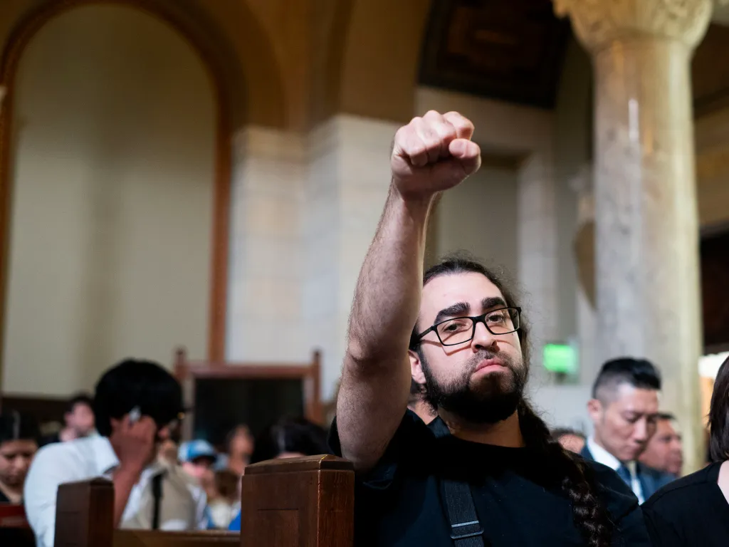 A member of the LA Valley Gun Club raises a fist at a budget and finance committee meeting at City Hall in Downtown Los Angeles.