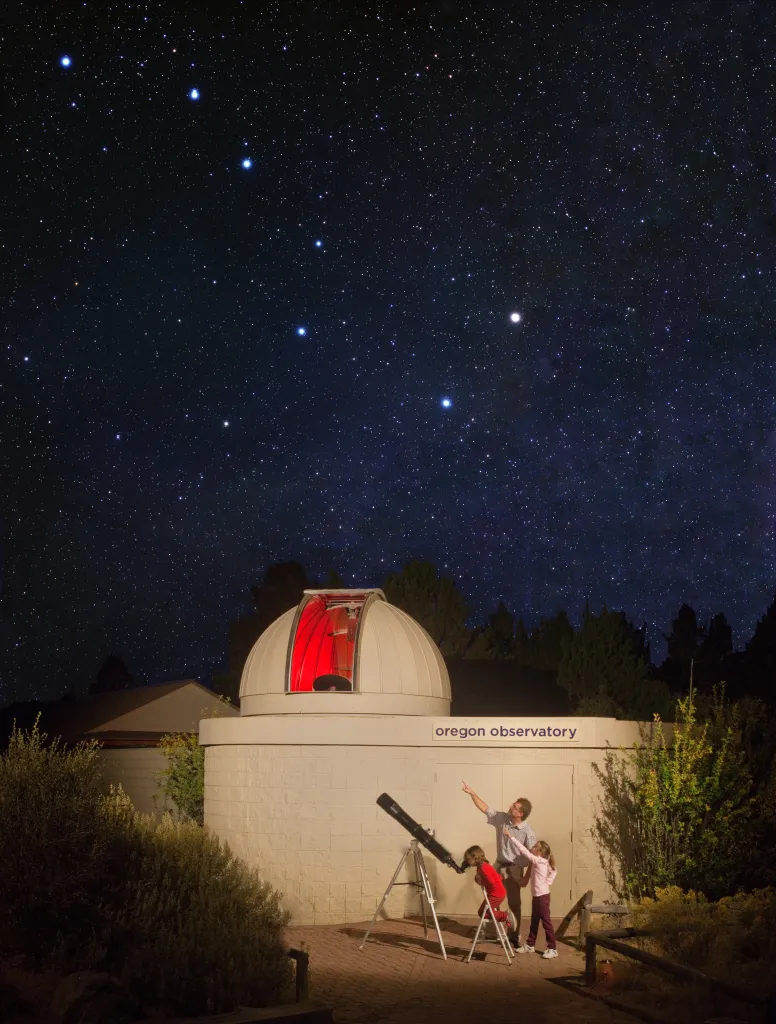 A family looking at the stars outside the Oregon Observatory.