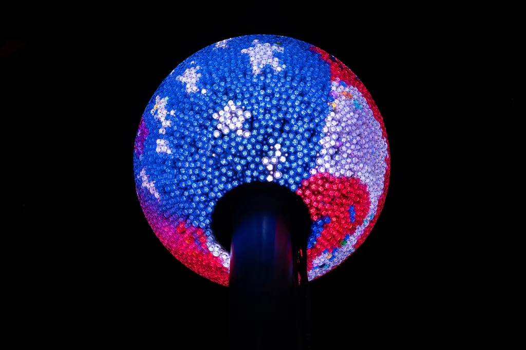 A specially designed America250 ball, patterned with blue and red lights to evoke the American flag, illuminates the darkness.