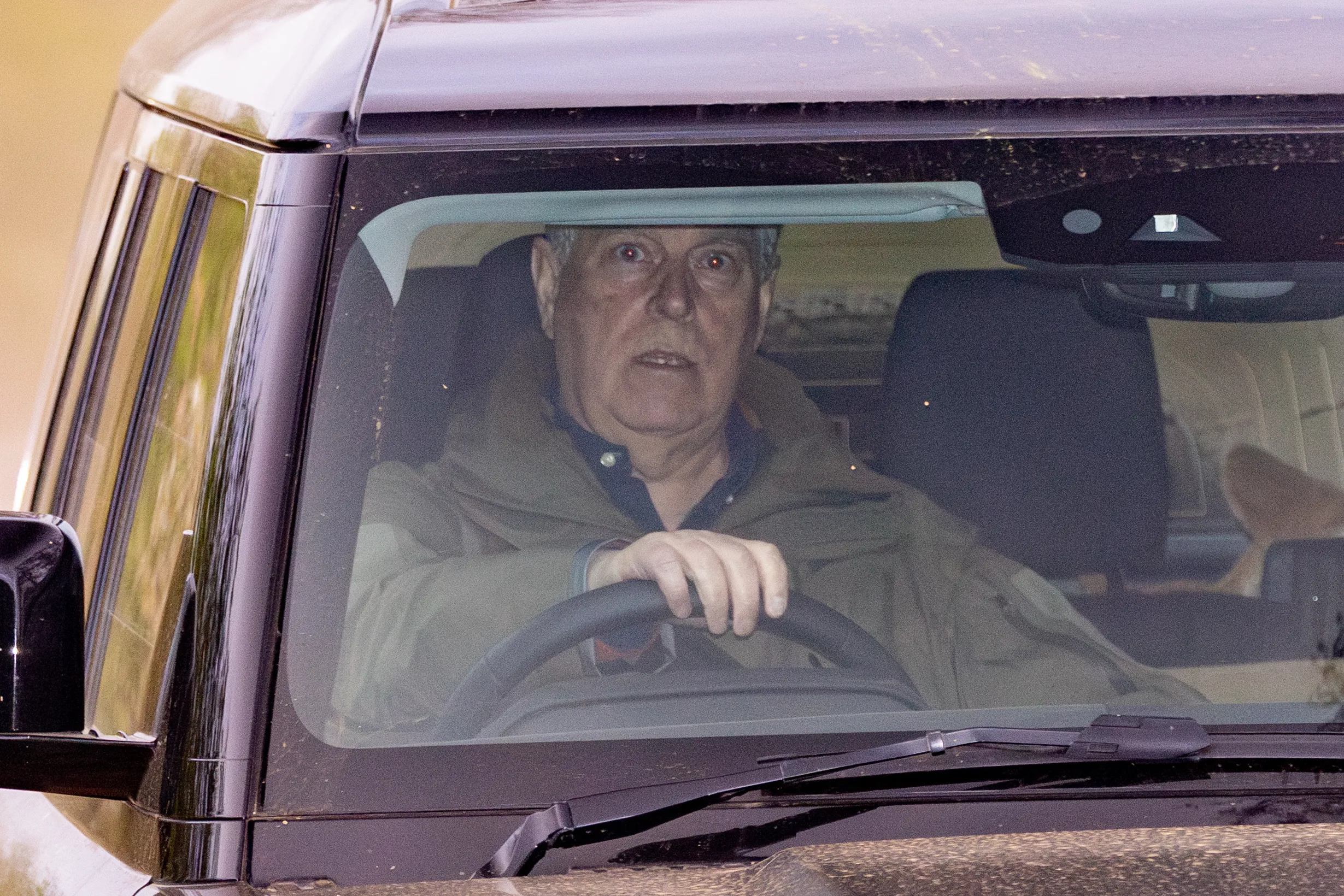 Prince Andrew, Duke of York, driving a Range Rover.