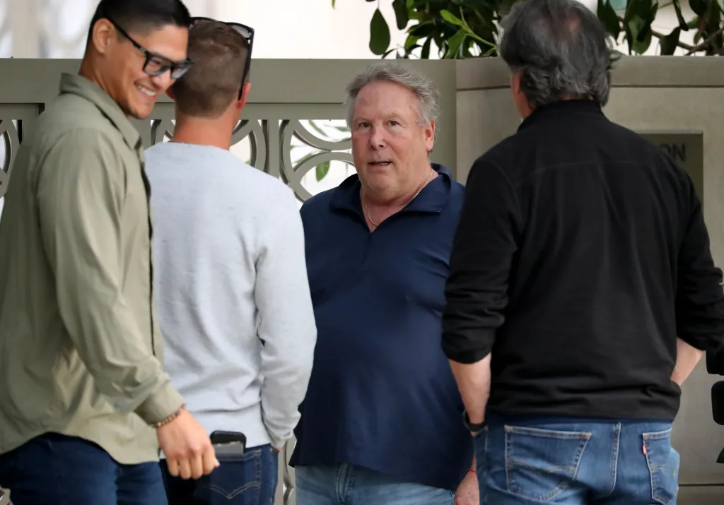 Stephen Cloobeck speaks to a news crew outside his mansion.