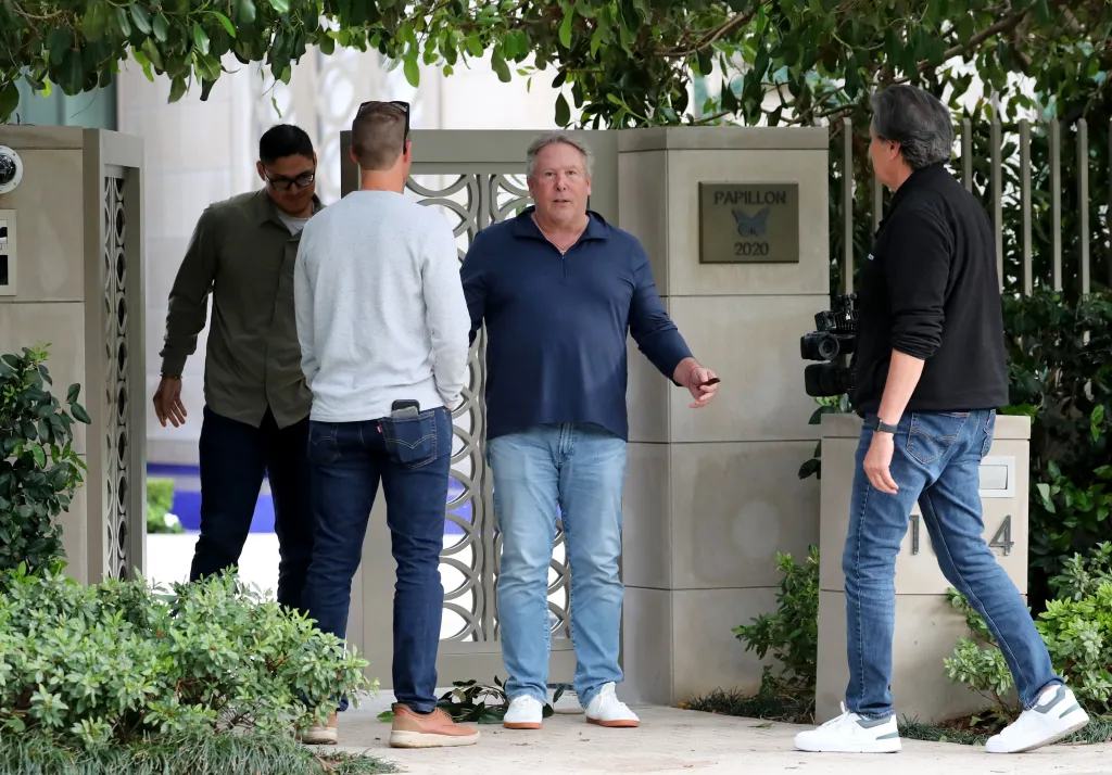 Stephen Cloobeck speaks to a news crew outside his mansion.