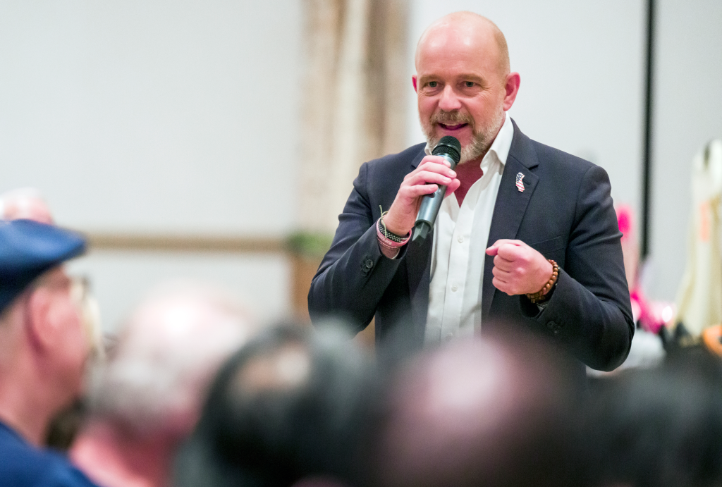 Steve Hilton, California gubernatorial candidate, speaks into a microphone at a town hall.