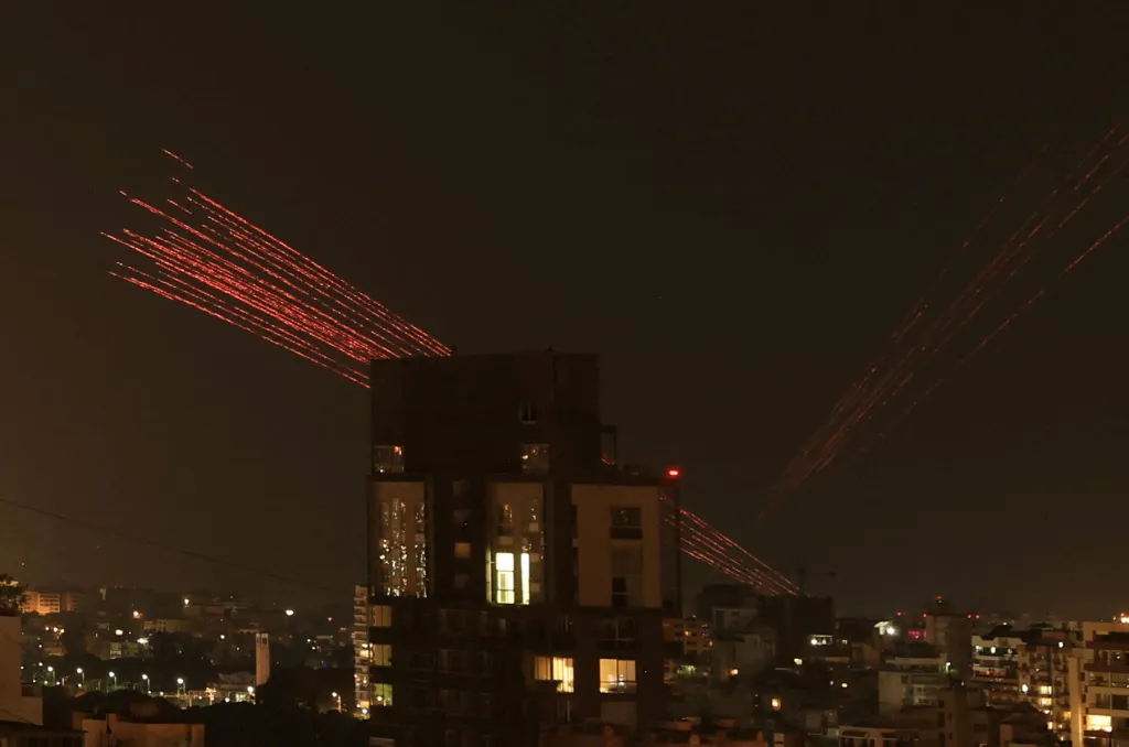 Tracer fire streaks across the night sky above Beirut, celebrating a ceasefire.