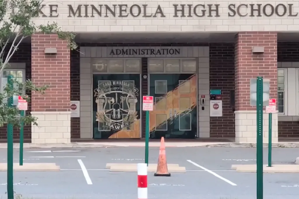 Exterior of Lake Minneola High School administration building with brick facade and glass doors.