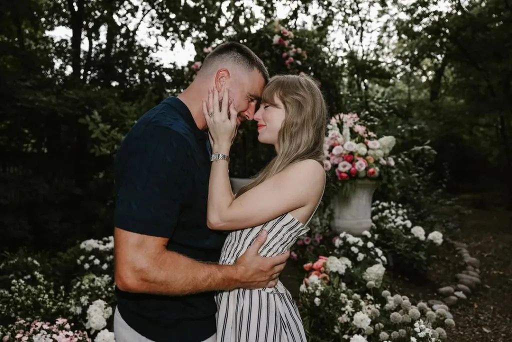 Taylor Swift and Travis Kelce embracing with foreheads touching.
