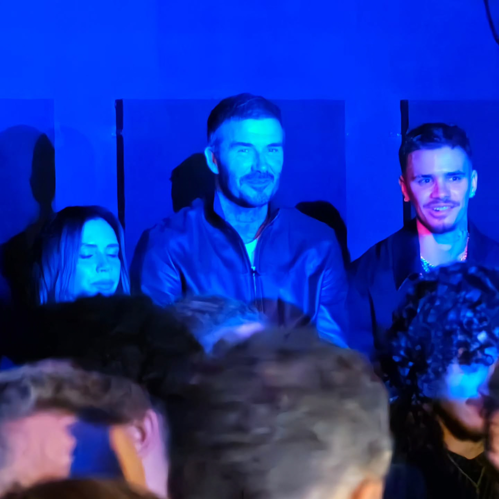 David Beckham, Victoria Beckham, and Romeo Beckham in the audience.