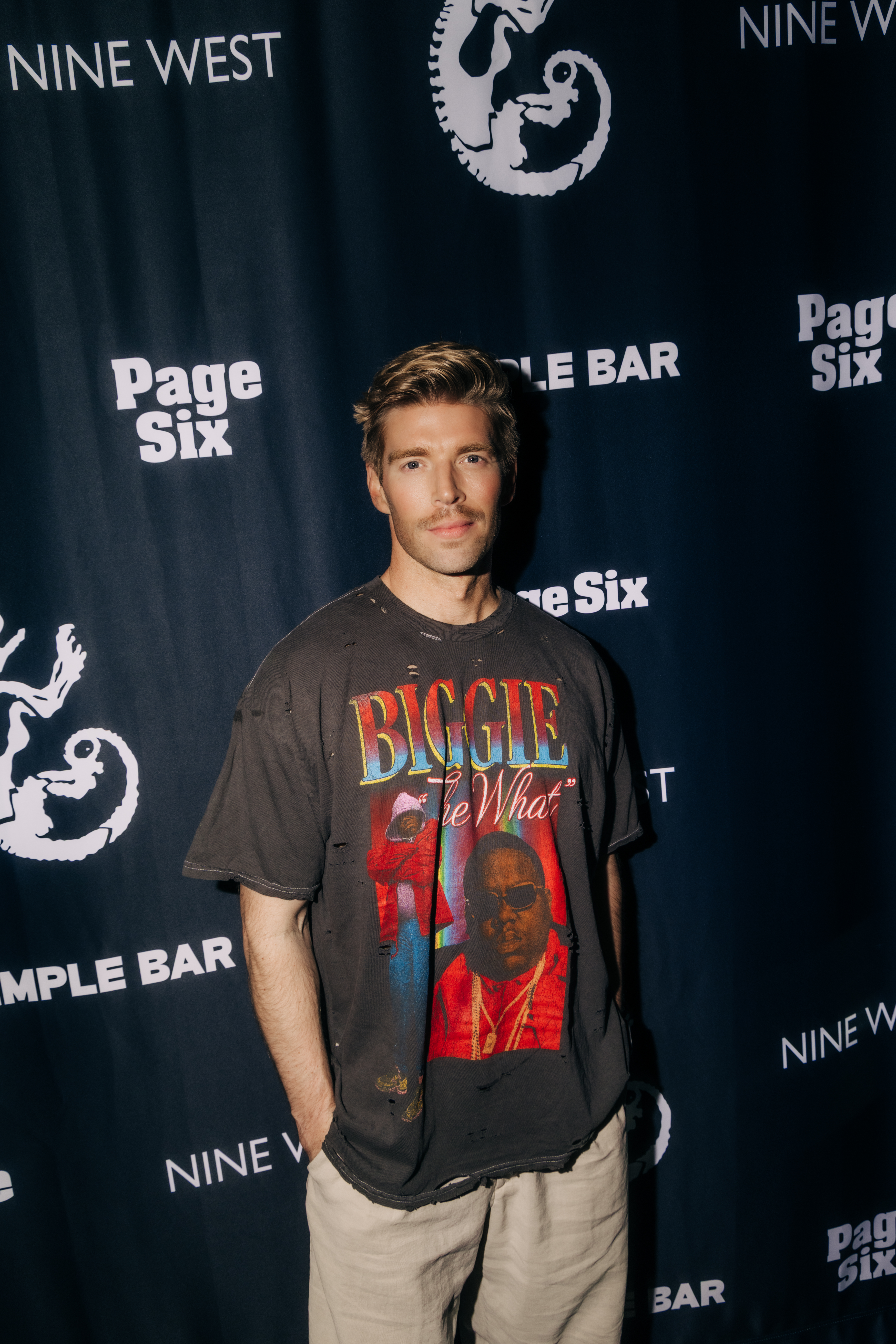 Kyle Cook wearing a distressed Biggie Smalls t-shirt and tan pants.