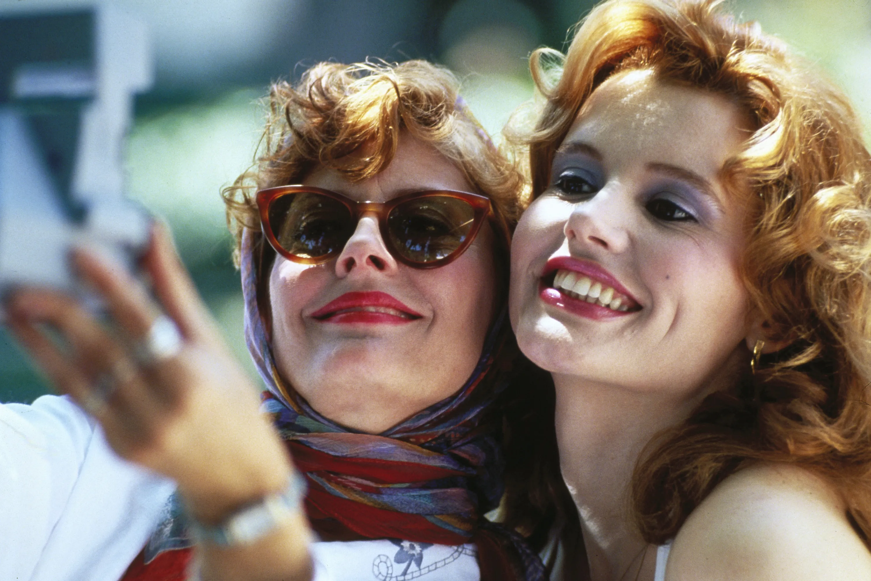 Susan Sarandon and Geena Davis as Thelma and Louise posing for a photo.