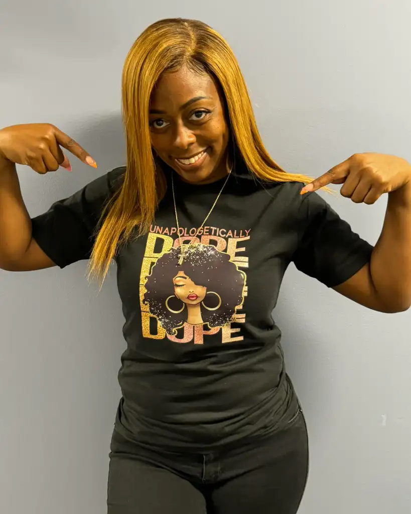 Dolton, Illinois Mayor Tiffany Henyard pointing to her black t-shirt that says 