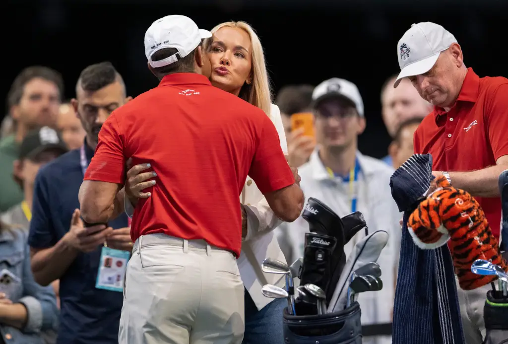 Tiger Woods getting a hug and kiss from Vanessa Trump during the TGL finals.