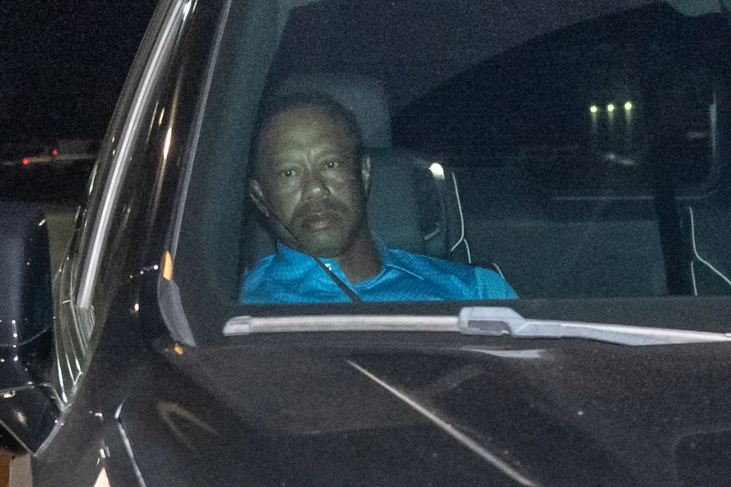 Tiger Woods in the back seat of a car.
