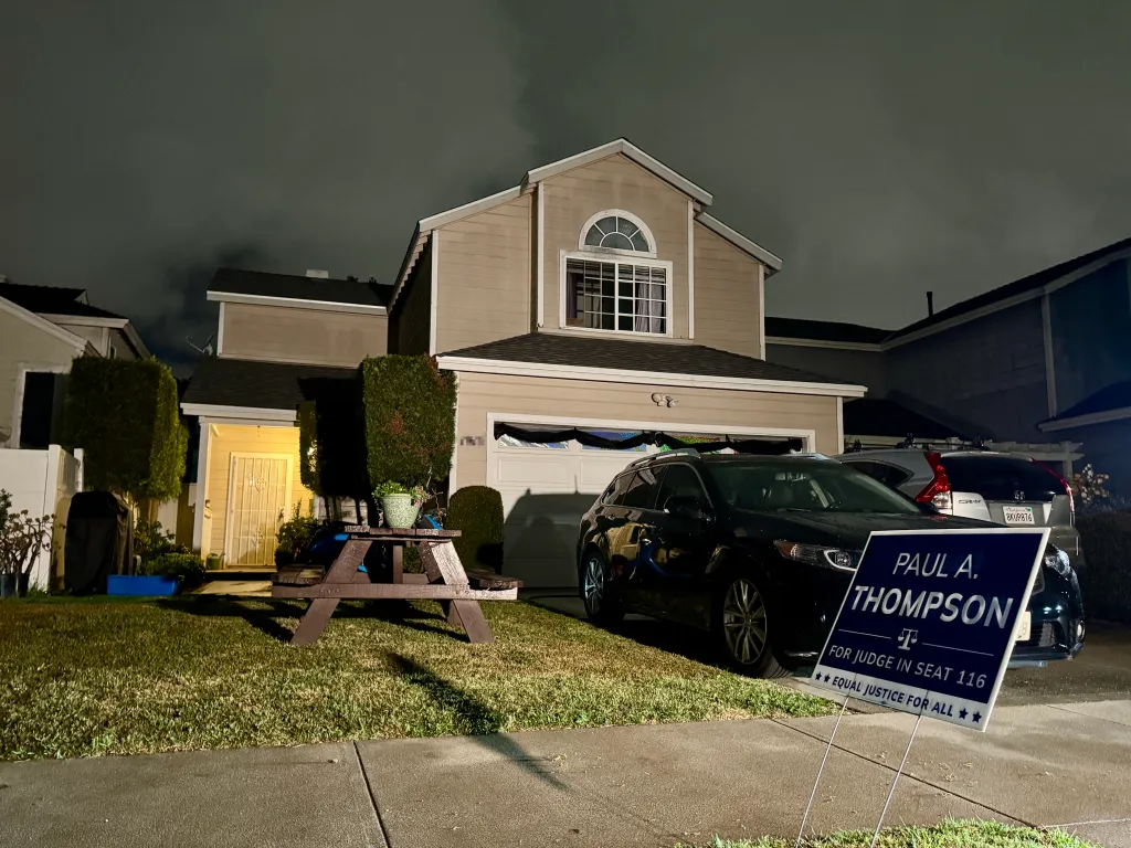 Nighttime view of a two-story house with a 