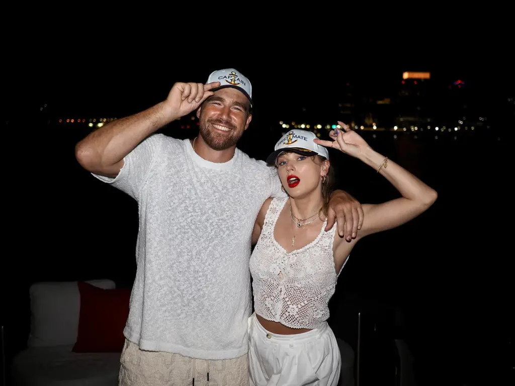 Travis Kelce and Taylor Swift wearing matching 