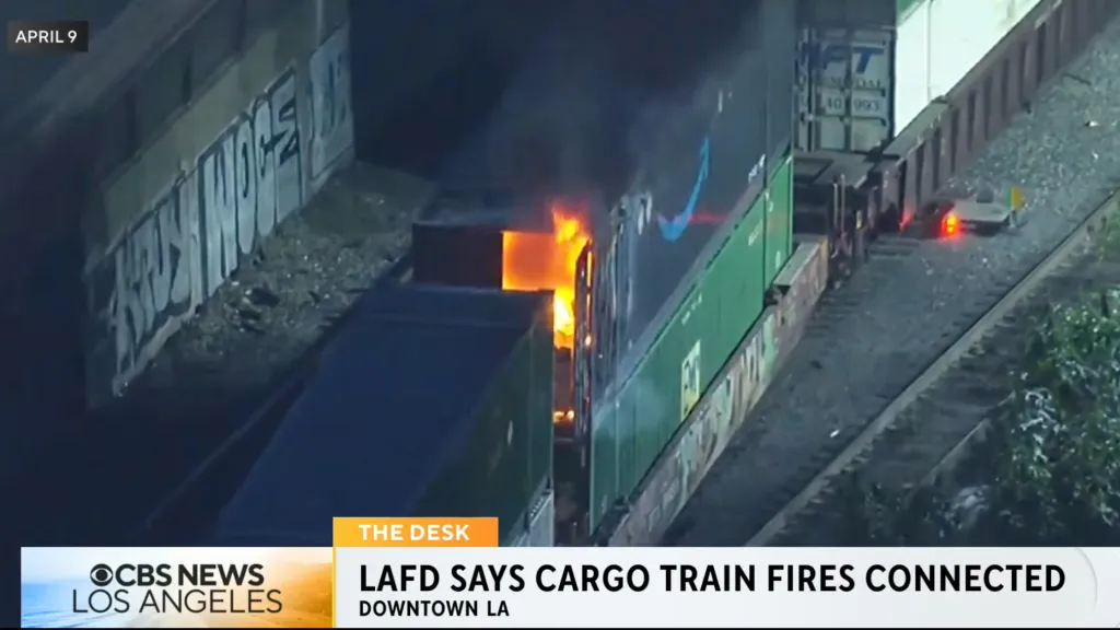 Fire engulfing an Amazon cargo container on a train in Boyle Heights.