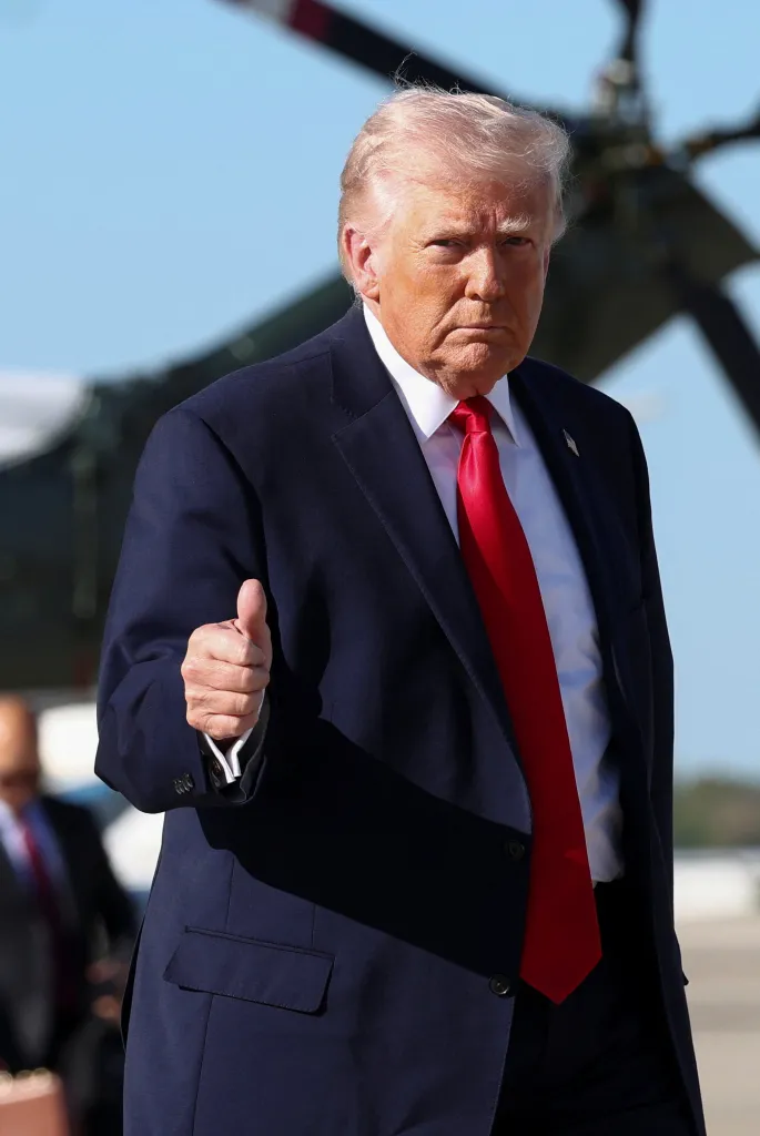 Donald Trump gives a thumbs-up as he boards Air Force One.