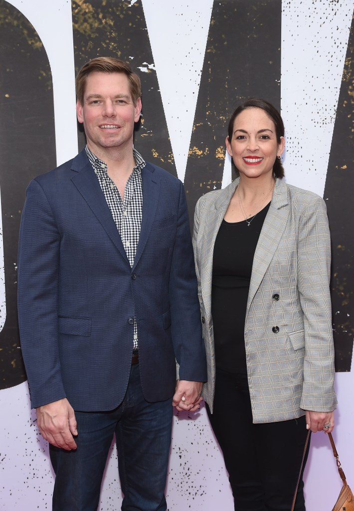 U.S. Representative Eric Swalwell and wife Brittany Watts holding hands.