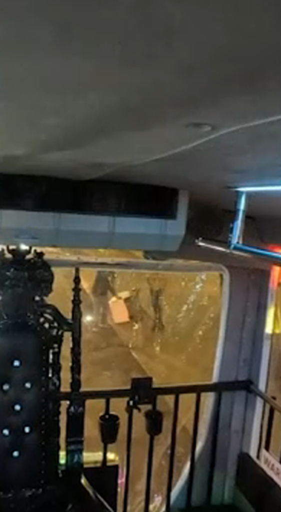 Uber Eats robot behind a clear barrier.