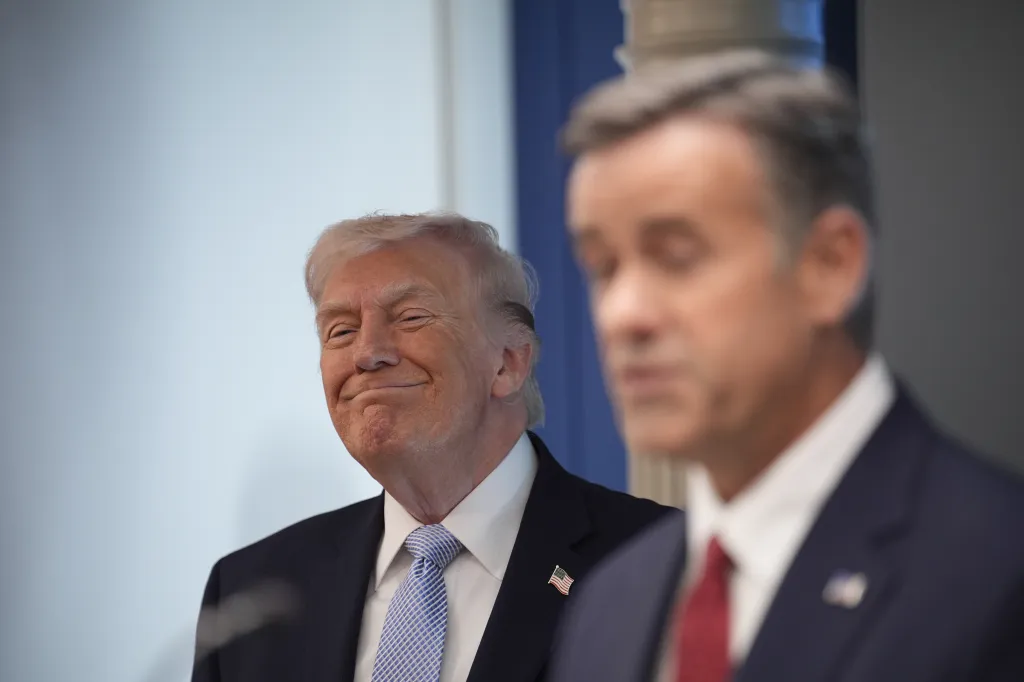Donald Trump smiles during a press conference with John Ratcliffe, Director of the Central Intelligence Agency (CIA).