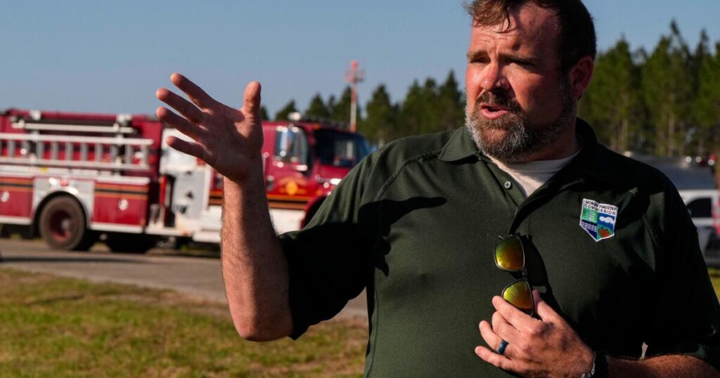 Southern U.S. wildfires force residents to flee, leaving them unsure if their homes are standing