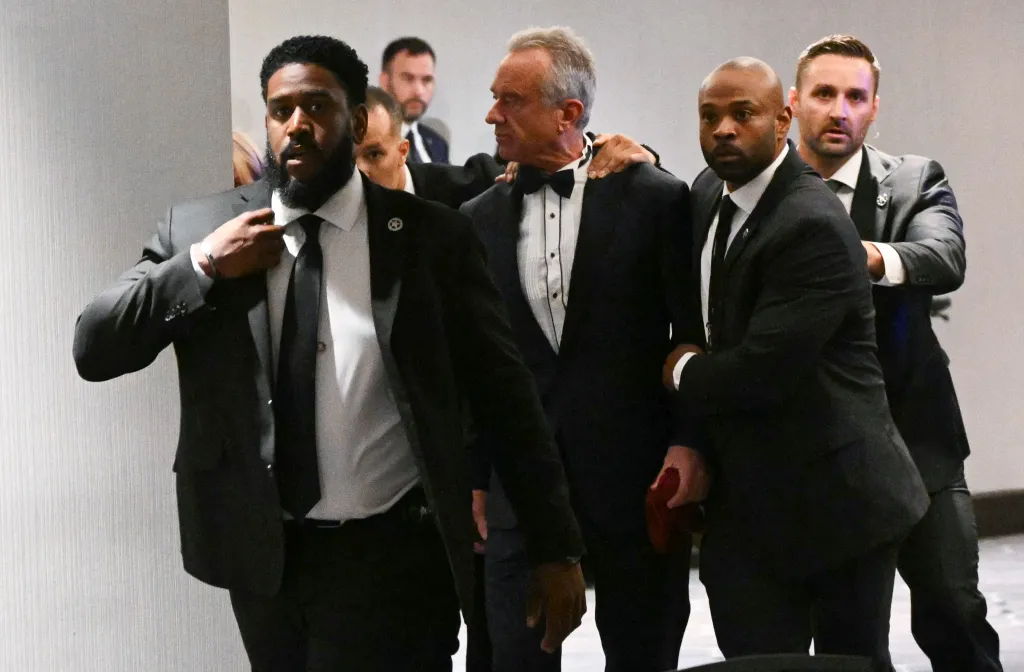 Robert F. Kennedy Jr. being rushed out by Secret Service agents during the White House Correspondents' dinner.