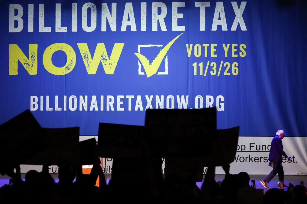 Senator Bernie Sanders walks past a 