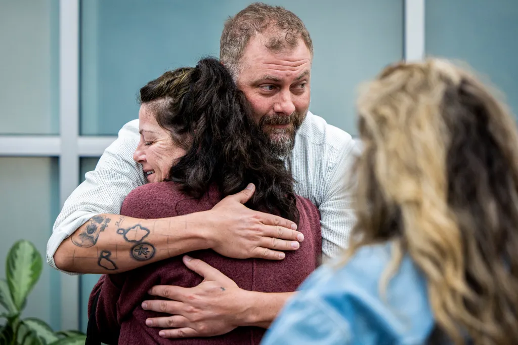 Laura Ann Aime's youngest sister, Tommi Aime, hugs Utah County Sheriff' Deputy Jake Hall after officials confirmed the teen was murdered by Ted Bundy.