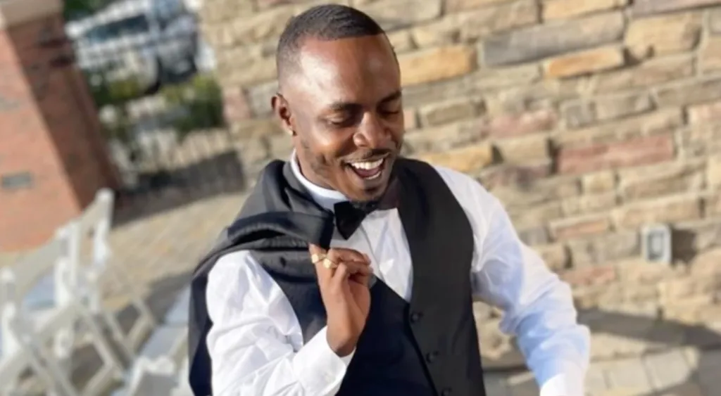 Malcolm Watson, the 28-year-old victim, smiling while wearing a black suit and bow tie.