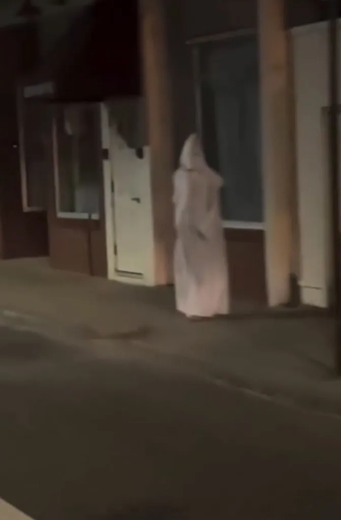 The hooded figure was filmed walking down Main Street in West Warwick, Rhode Island.