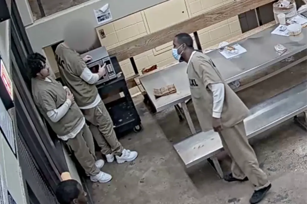 An individual in custody lighting a wick in a microwave, creating sparks.