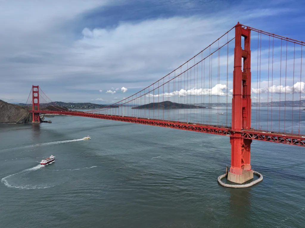 Golden Gate Bridge in San Francisco with two boats on the water below.