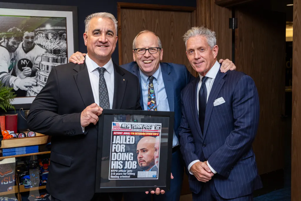 Vincent Vallelong, John Ledecky, and Pat Judge posing with a framed New York Post newspaper with the headline