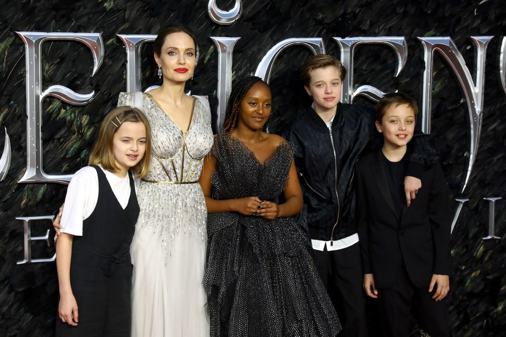 Angelina Jolie poses with her children Vivienne, Zahara, Shiloh, and Knox at the 