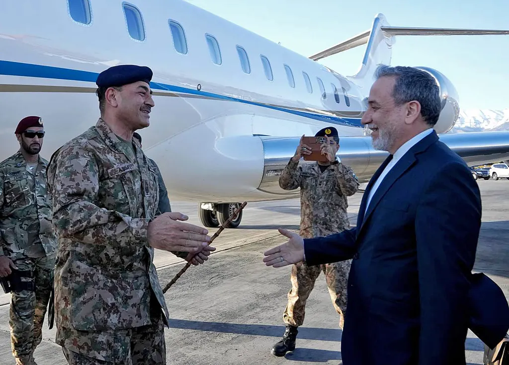 Iran's Foreign Minister Abbas Araghchi (R) welcoming Pakistan's Army Chief Asim Munir upon his arrival at the airport in Tehran.