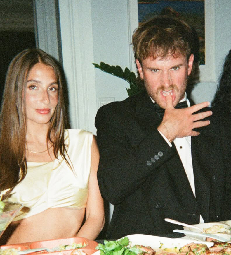 West Wilson and Amanda Batula sitting at a table with food.