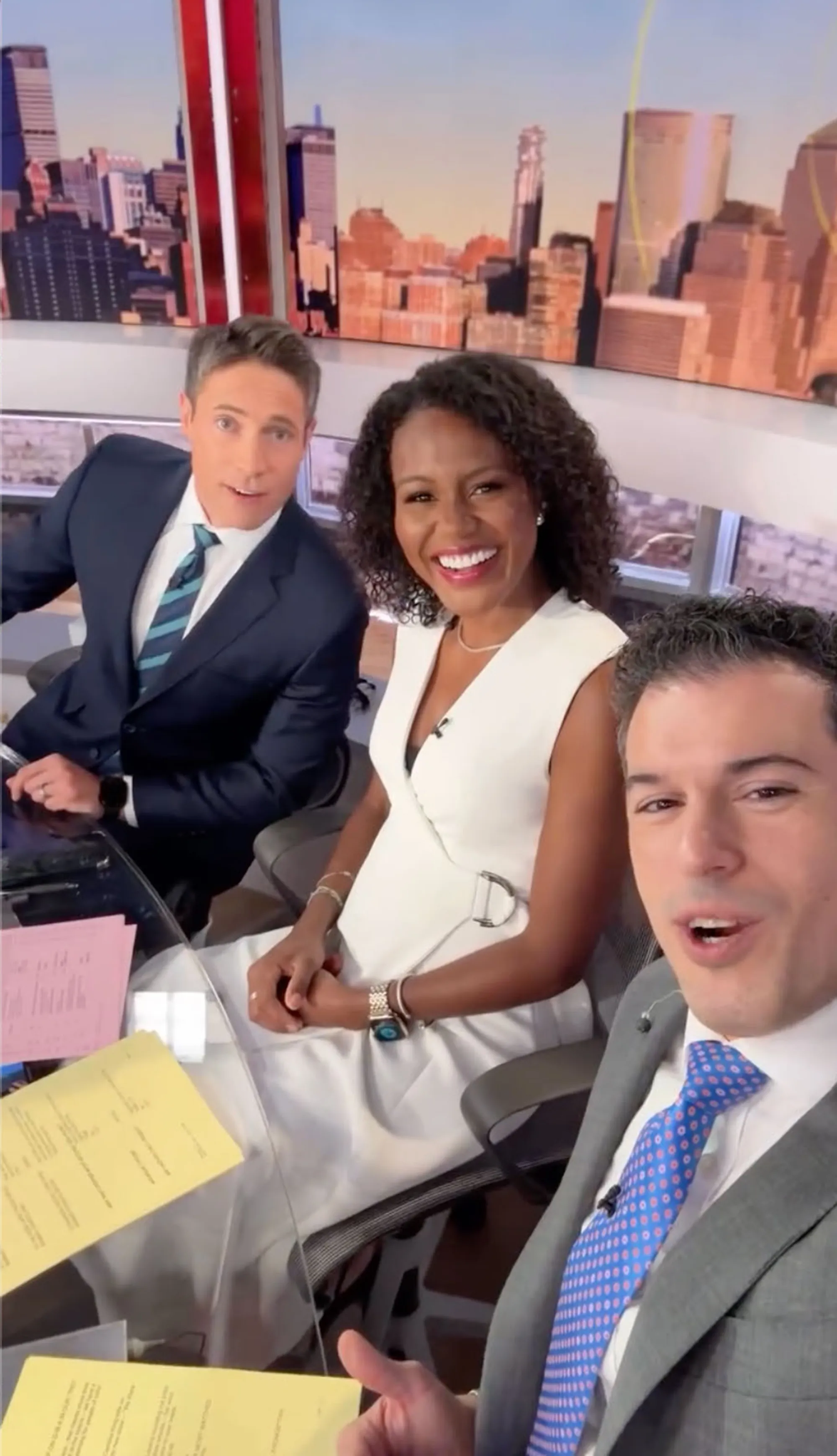 Whit Johnson, Janai Norman, and Gio Benitez smiling in a news studio.